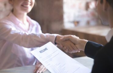 Man and woman shaking hands in job interview